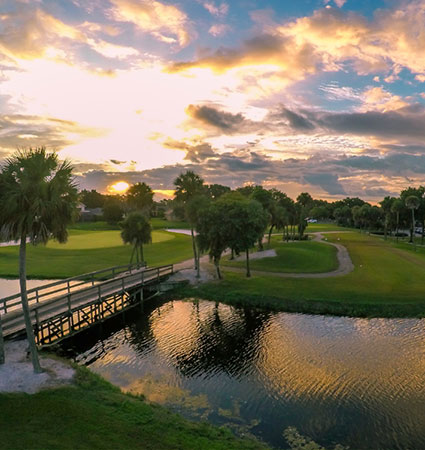 Pond on golf course green with bridge